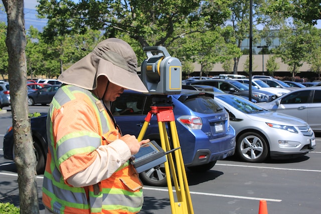 Man in car park surveying